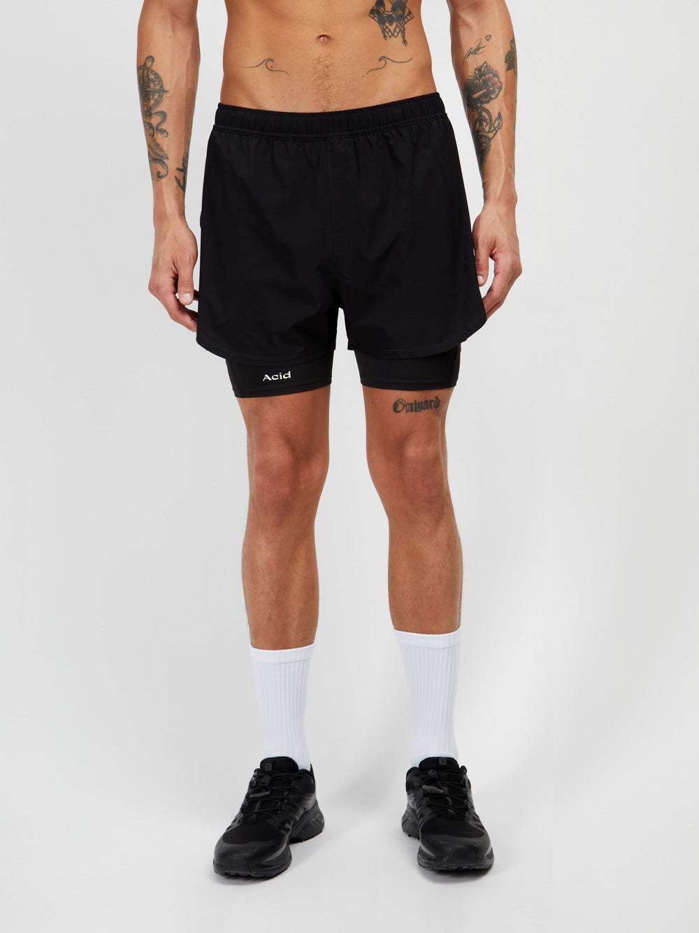 2-in-1 black shorts with lightweight shell and compression inner, made from recycled polyester.